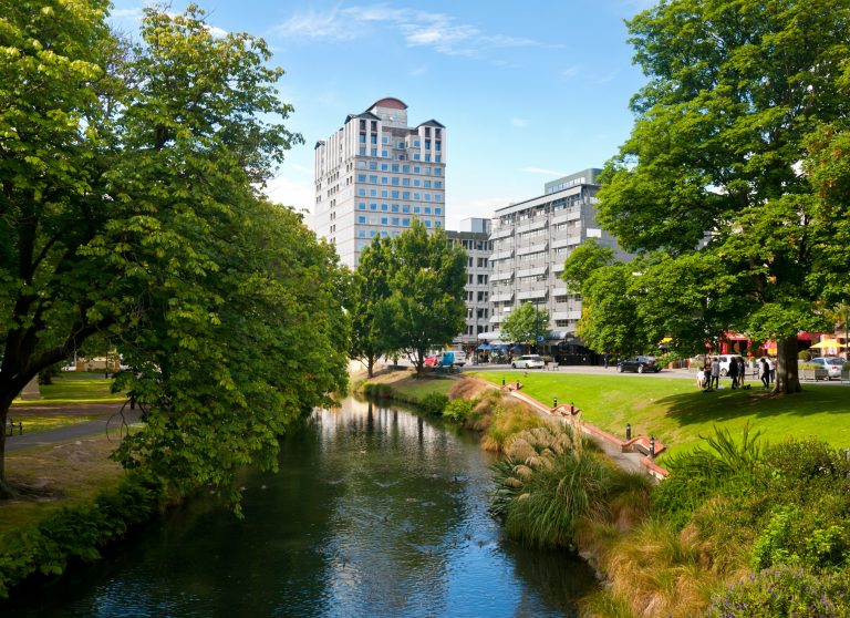 Christchurch cityscape with creek and green trees